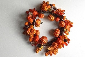 22072 - Autumn / Halloween Wreath with an array of golden orange fruits and berries and a scattering of pine cones and bark. Measures  380mm diameter