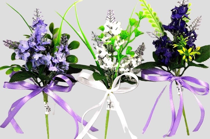 33002 - Floral arrangement with delicate flowers and leaves embellished with a satin bow.  Height  20cms ,  Width  11cms  (approx) 
