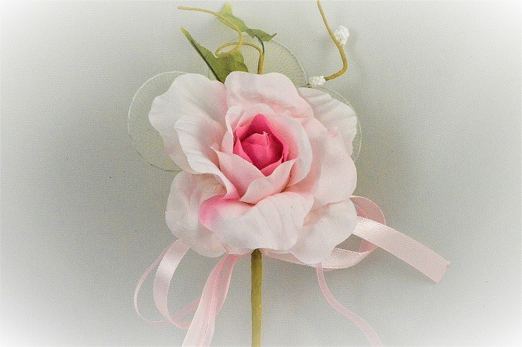 33014 - Delicate Pink rose floral arrangement with satin and organza bow and other embellishments.  Height  18cms ,  Width 17cms  (approx) 