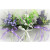 33002 - Floral arrangement with delicate flowers and leaves embellished with a satin bow.  Height  20cms ,  Width  11cms  (approx) 