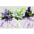 33002 - Floral arrangement with delicate flowers and leaves embellished with a satin bow.  Height  20cms ,  Width  11cms  (approx) 